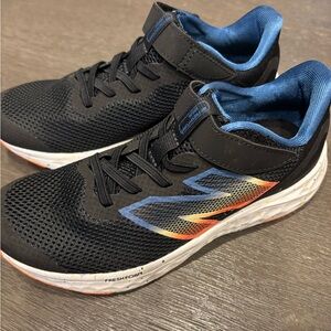New Balance Kids' Black Sneakers with Blue and Yellow Accents